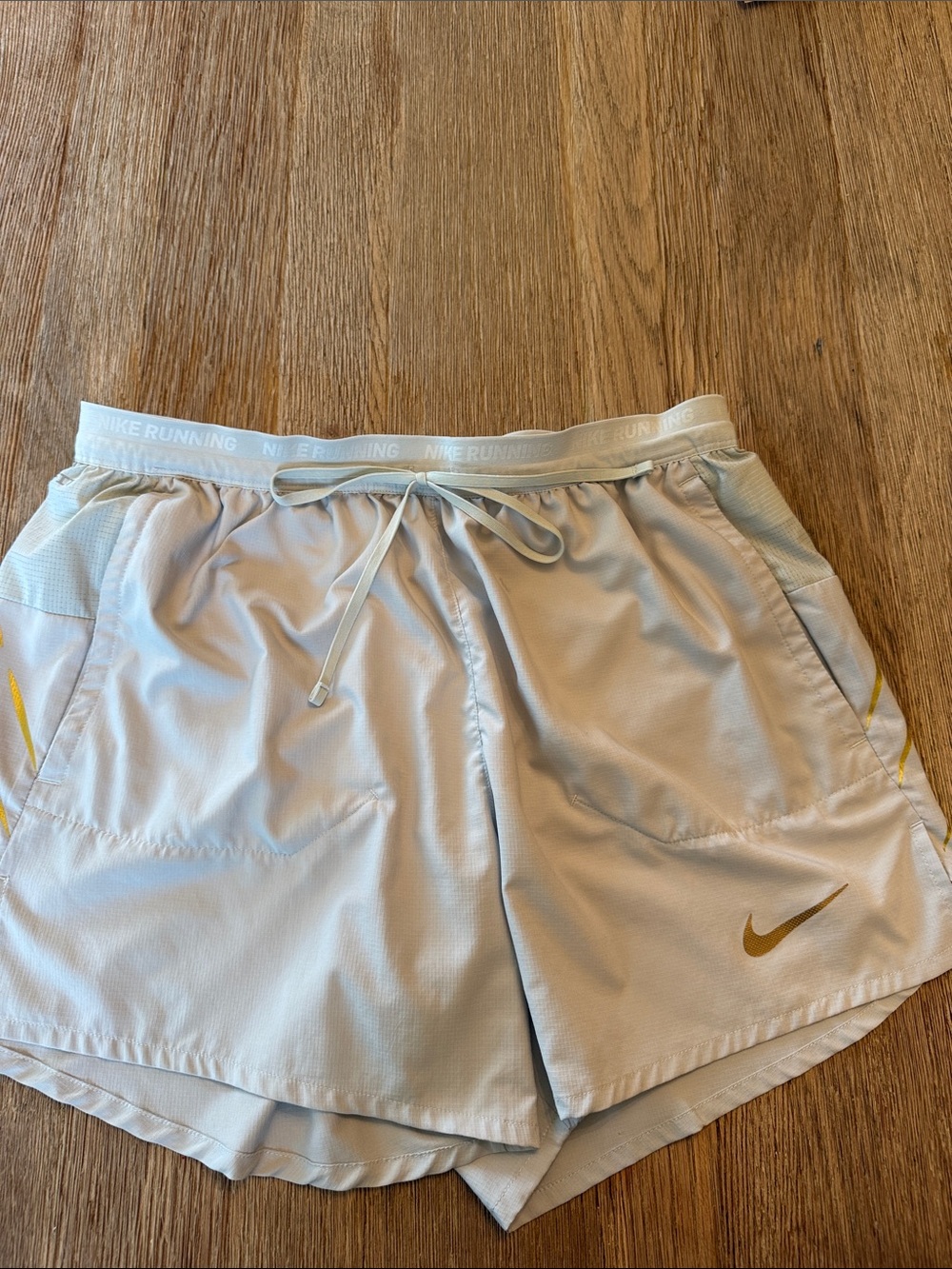 Nike Light Green Athletic Running Shorts with Gold Swoosh
